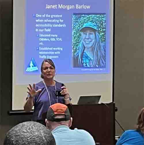 Picture shows Jen presenting, on the screen we see a picture of Janet Barlow with a title 'Janet Morgan Barlow.'